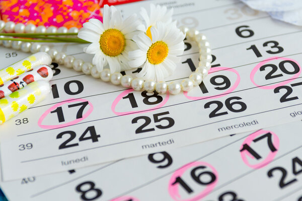 Woman hygiene protection, close-up.menstruation calendar with cotton tampons