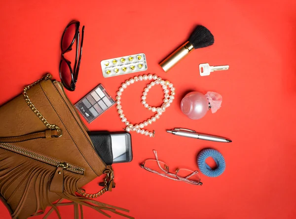 Top view of female accessories and phone on a red background — Stock Photo, Image