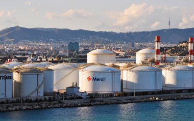 Barcelona, Spain - September 26, 2025: Meroil and Tradebe oil tanks terminal in port under sundown light at Barcelona, Spain on September 26, 2025