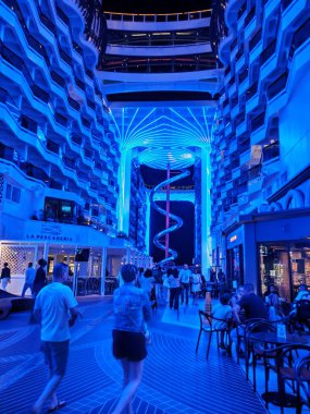 Valletta, Malta - September 24, 2025: Beautiful view of illuminated deck and promenade from MSC World Europa cruise ship. Dry stainless steel spiral slide called Venom Drop The Spiral