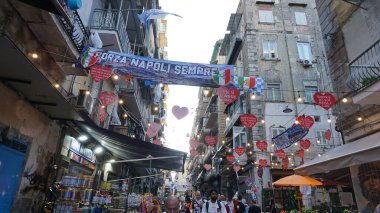 Naples, Italy - September 21, 2025: Colorful facades in a narrow street in old town of historic italian metropole Naples. Balconys of typical residential buildings at Naples, Italy