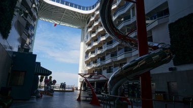 Valletta, Malta - September 24, 2025: Beautiful view of deck and promenade from MSC World Europa cruise ship. Dry stainless steel spiral slide called Venom Drop The Spiral