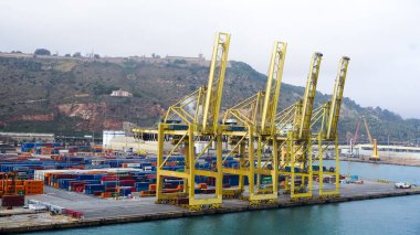 Barcelona, Spain - December 19, 2025: Cranes in the container terminal in the port of Barcelona