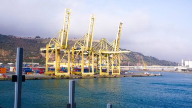 Barcelona, Spain - December 19, 2025: Cranes in the container terminal in the port of Barcelona