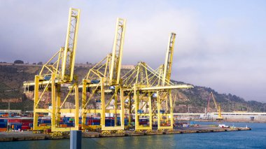 Barcelona, Spain - December 19, 2025: Cranes in the container terminal in the port of Barcelona