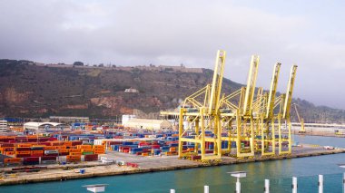 Barcelona, Spain - December 19, 2025: Cranes in the container terminal in the port of Barcelona