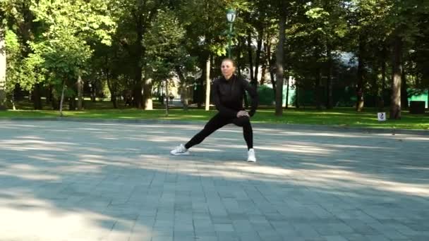 Mulher esticando as pernas no parque — Vídeo de Stock