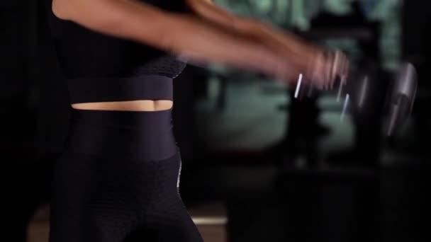 Fit woman working out with kettlebell in gym in the dark — Stock Video