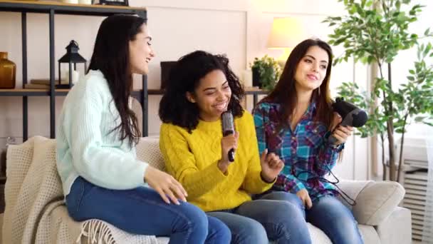 Multiethnic friends singing karaoke at home — Stock Video