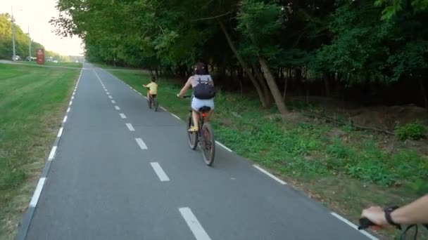 Active family biking on bike lane near forest — Vídeo de Stock