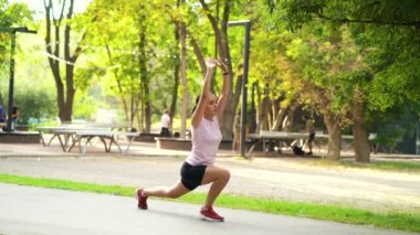 Woman in sportswear doing exercises in park
