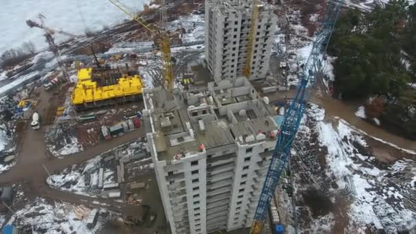Luchtfoto van het bouwen van wolkenkrabber met werknemers aan de top — Stockvideo