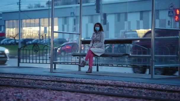 Mulher sentada sozinha na parada de bonde — Vídeo de Stock