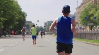 Adam yavaş çekimde şehir maratonunda koşuyor.
