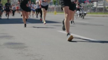 Maratonda yarışan insanların bacakları