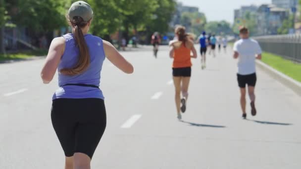 Плюс женщина размера бежит марафон и проверяет пульс — стоковое видео