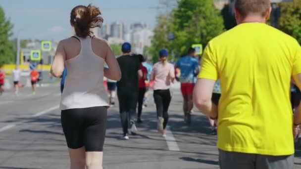 Slow motion woman running marathon in city — Stock Video