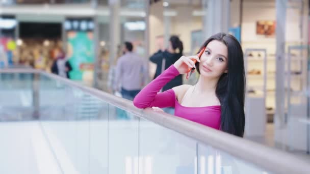 Vrolijke vrouw aan de telefoon in het winkelcentrum — Stockvideo