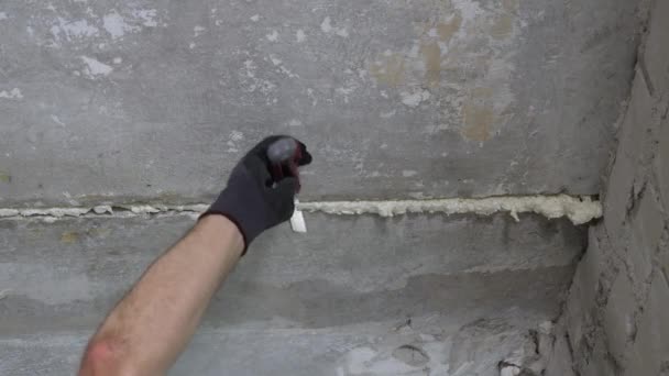 Mão na luva removendo espuma do teto — Vídeo de Stock