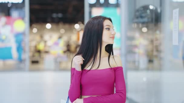 Hermosa mujer caminando en el centro comercial y mirando maniquíes en ropa interior — Vídeos de Stock