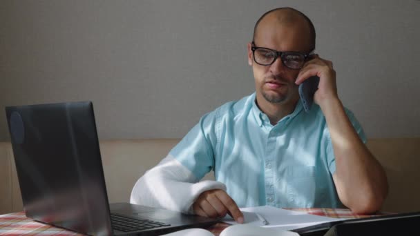 Empresário com braço quebrado falando por telefone — Vídeo de Stock