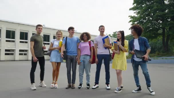 Happy students showing thumbs up near college — Stok Video