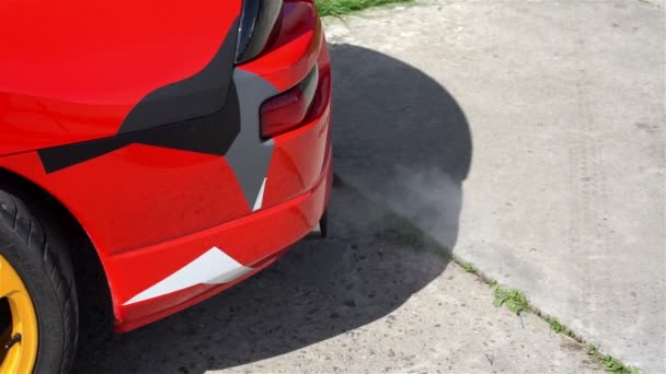 Fechar o tubo de escape do carro esporte liberando fumos, queima de combustível, poluição do ar — Vídeo de Stock