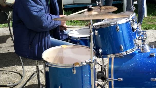 Drummer playing light song, checking sound before concert, outdoor festival — Stock Video