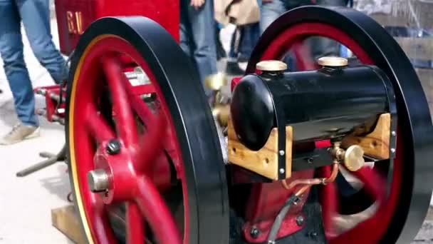 Mechanical engineer starting an old diesel engine at exhibition, closeup view