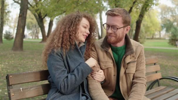 Νεαρό κοκκινομάλλικο ζευγάρι που μιλάει, περνάει χρόνο μαζί στο πάρκο, ρομαντικό ραντεβού — Αρχείο Βίντεο