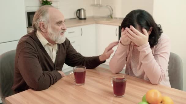 Senior man troostende huilende dochter, samen zitten in de keuken, ondersteuning — Stockvideo