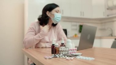 Maskeli hasta kadın internette doktorla konuşuyor, reçeteli ilaç yazıyor.