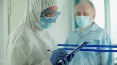 Koruyucu üniforma doldurma, koronavirüs izolasyonu konusunda uzman.