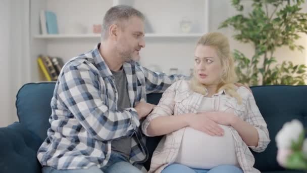 Offended pregnant woman ignoring husband at home, family communication, conflict — Stock Video