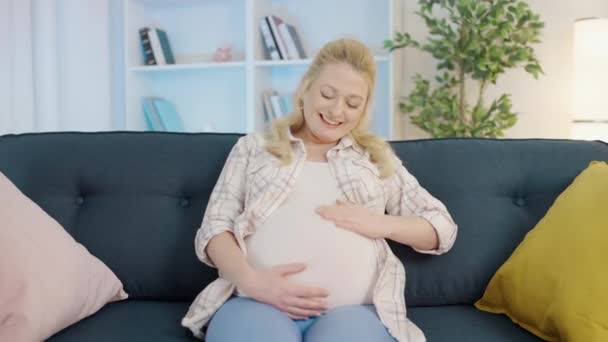 Happy pregnant female touching belly, talking to baby in womb, communication — Stock Video