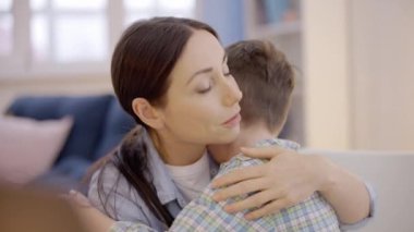 Evde ağlayan çocuğu destekleyen genç bir kadın, aile ilişkisi, annelik.