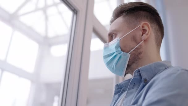 Maskeli Genç Adam Hastanenin Penceresinden Dışarı Bakıyor Evde Kendini Izole — Stok video