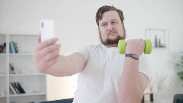 Positive Chubby Male Flirting Camera Holding Dumbbell Pretending Slim — Stock Video