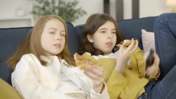 Young Women Resting Couch Enjoying Pizza Watching Movie Lazy Weekend — Stock Video