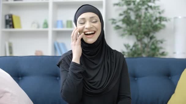 Smiling Muslim Woman Talking Smartphone Couch Communication Technology — Stock Video