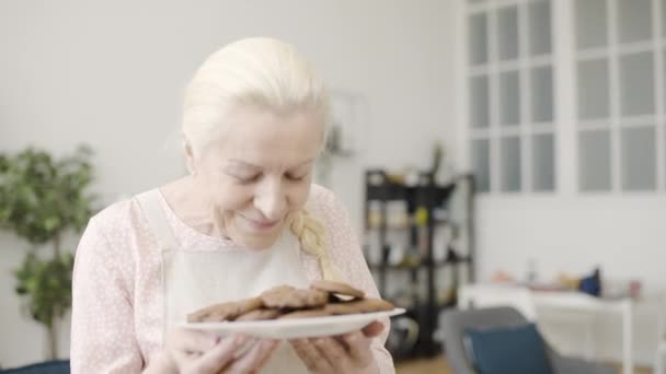 Pleased Senior Woman Smelling Freshly Baked Homemade Cookies Cooking Hobby — Stock Video