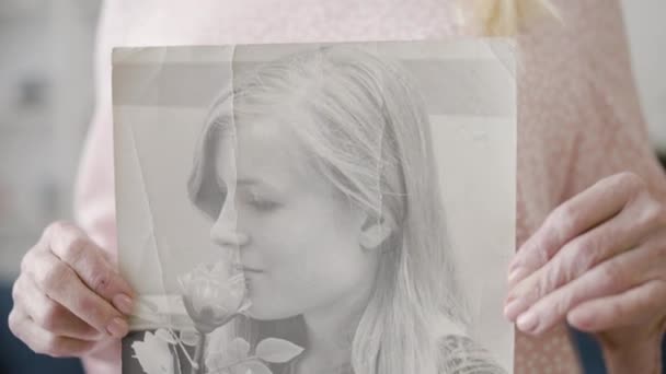 Smiling Senior Woman Holding Old Photo Herself Remembering Youth — Stock Video