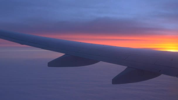 Airplane wing with sunset and clouds — Stock Video