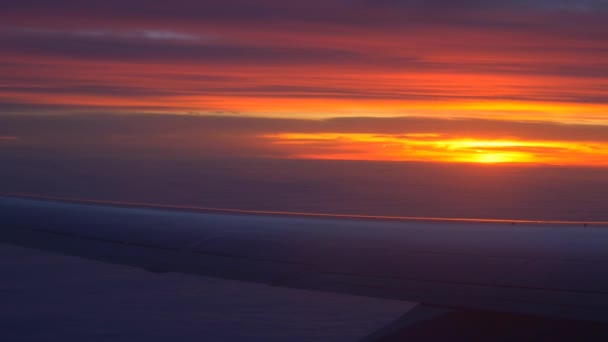 Airplane wing with sunset and clouds — Stock Video