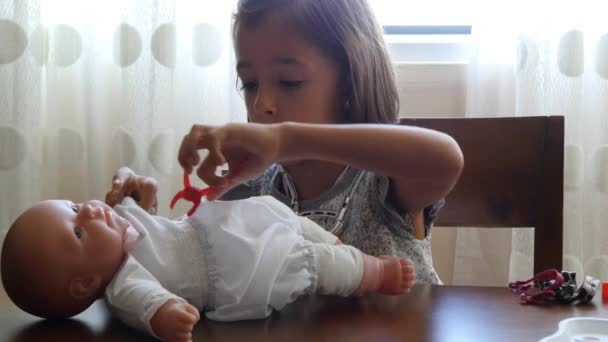 Girl Playing Doctors with Doll — Stock Video