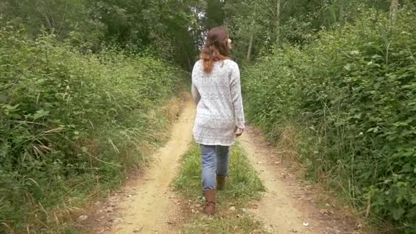 Woman walking in rural road — Stock Video