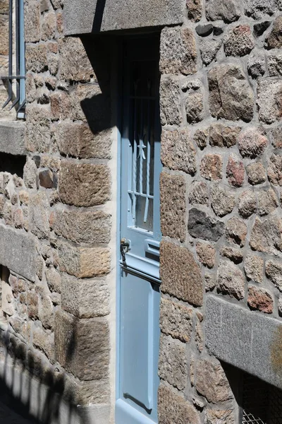 Old blue door in rocky castle.