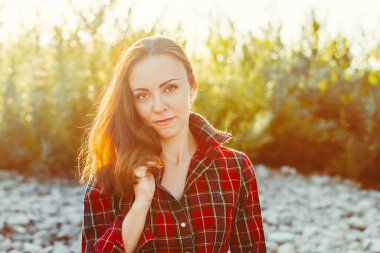 Güneşli bir günde yeşil çimlerin üzerinde güzel bir kız.