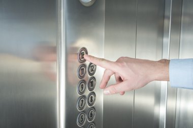 Asansörde düğmesine basarak