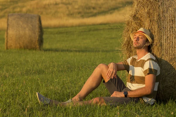 Samanlık eğilerek buğday alanında genç adam